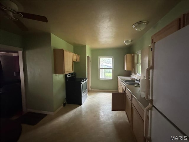 6 Maple Dr, Caseyville, IL 62232 - kitchen with electric stove, freestanding refrigerator, a ceiling fan, and light brown cabinetry