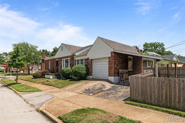 6736 Julian Ave, University City, MO 63130 - view of front of home with brick siding, an attached garage, and driveway