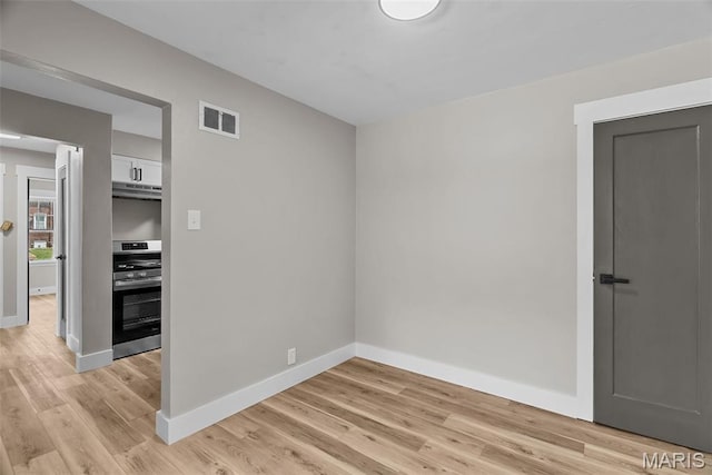 6736 Julian Ave, University City, MO 63130 - unfurnished room featuring baseboards and light wood-type flooring