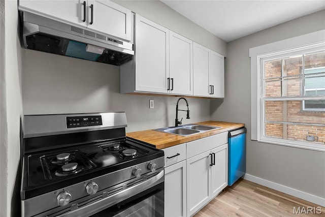6736 Julian Ave, University City, MO 63130 - kitchen featuring stainless steel range oven, under cabinet range hood, dishwasher, wooden counters, and light wood finished floors