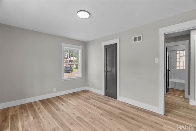 6736 Julian Ave, University City, MO 63130 - unfurnished bedroom featuring light wood-style flooring