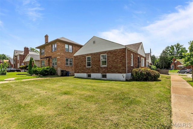 6736 Julian Ave, University City, MO 63130 - view of property exterior with brick siding and a yard