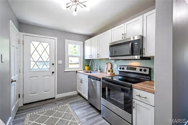 1900 Owen Dr, Hanley Hills, MO 63133 - kitchen with stainless steel appliances, light wood finished floors, and white cabinets