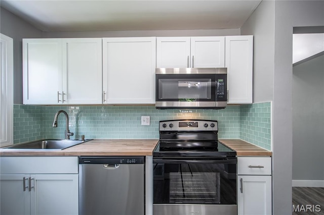 1900 Owen Dr, Hanley Hills, MO 63133 - kitchen with appliances with stainless steel finishes, butcher block countertops, and white cabinetry