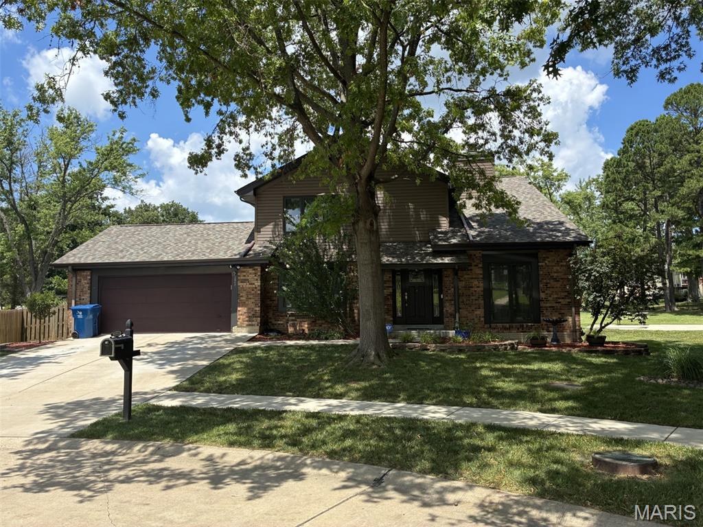 5225 Hettinger Ct, Mehlville, MO 63128 - view of front of house featuring concrete driveway, brick siding, an attached garage, and a shingled roof