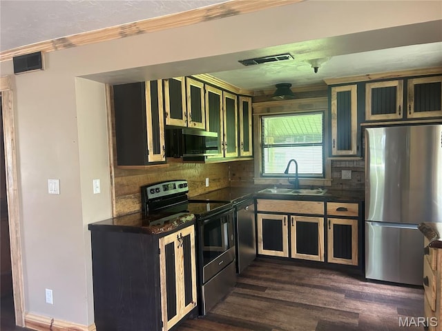 619 Don St, Poplar Bluff, MO 63901 - kitchen with appliances with stainless steel finishes, dark countertops, dark wood-style flooring, tasteful backsplash, and ornamental molding