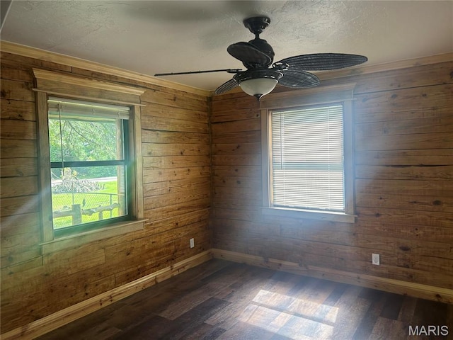 619 Don St, Poplar Bluff, MO 63901 - unfurnished room featuring dark wood-type flooring, wooden walls, ceiling fan, a textured ceiling, and crown molding