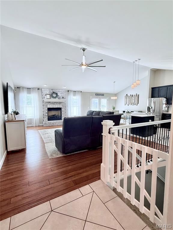 2354 Fountain Dr, Barnhart, MO 63012 - living room featuring ceiling fan, a fireplace, and light wood-style floors