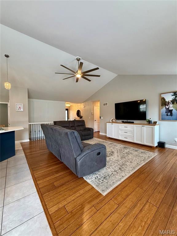 2354 Fountain Dr, Barnhart, MO 63012 - living room featuring a ceiling fan, vaulted ceiling, and light wood-style floors
