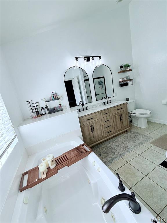 2354 Fountain Dr, Barnhart, MO 63012 - bathroom featuring double vanity, a tub with jets, and tile patterned flooring
