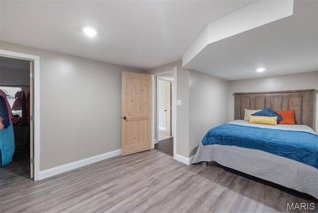 10317 Mallard Rd, Potosi, MO 63664 - bedroom featuring light wood finished floors, a spacious closet, and recessed lighting
