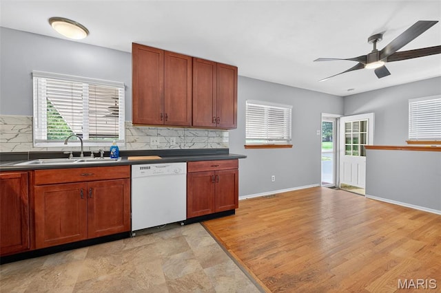 10564 Mert Ave, Saint Ann, MO 63074 - kitchen with white dishwasher, ceiling fan, dark countertops, and backsplash