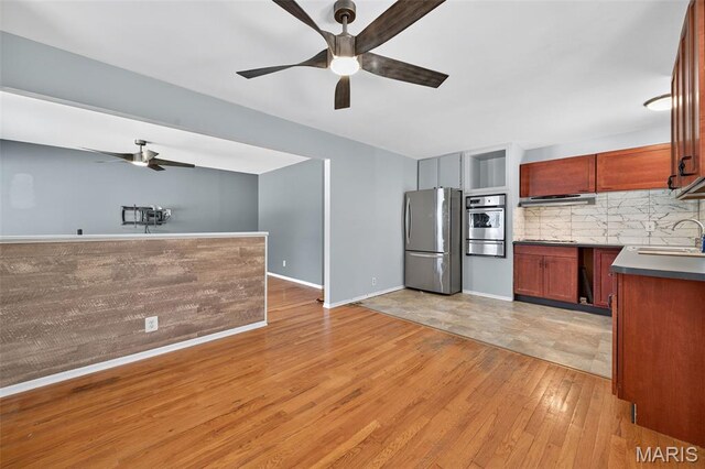 10564 Mert Ave, Saint Ann, MO 63074 - kitchen featuring stainless steel appliances, ceiling fan, backsplash, light wood-style flooring, and a warming drawer