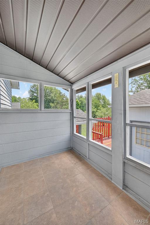 10564 Mert Ave, Saint Ann, MO 63074 - unfurnished sunroom featuring lofted ceiling and plenty of natural light