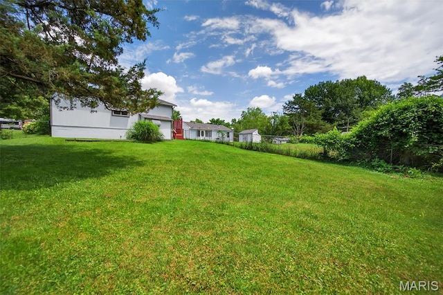 10564 Mert Ave, Saint Ann, MO 63074 - view of green lawn featuring an attached garage