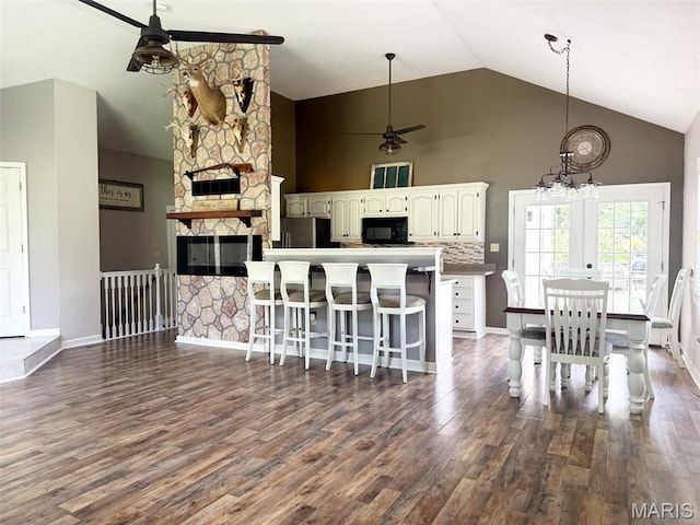 885 Oak Pass Ln, Sullivan, MO 63080 - kitchen with ceiling fan, black microwave, freestanding refrigerator, high vaulted ceiling, and dark wood-type flooring