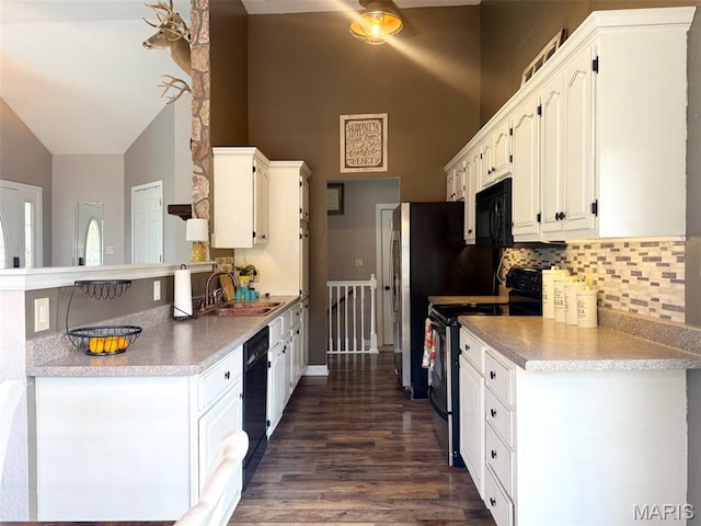 885 Oak Pass Ln, Sullivan, MO 63080 - kitchen featuring black appliances, high vaulted ceiling, backsplash, white cabinets, and dark wood finished floors
