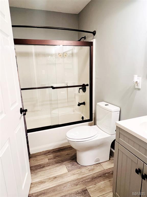 885 Oak Pass Ln, Sullivan, MO 63080 - bathroom with wood finished floors, vanity, and bath / shower combo with glass door