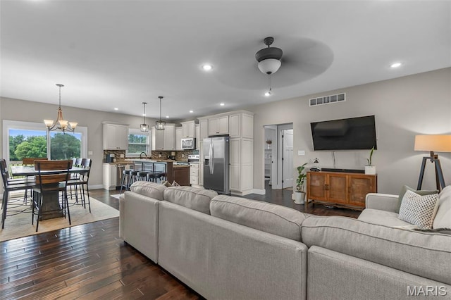 255 Sassenach Dr, Jackson, MO 63755 - living room with ceiling fan, recessed lighting, dark wood-style flooring, and a chandelier