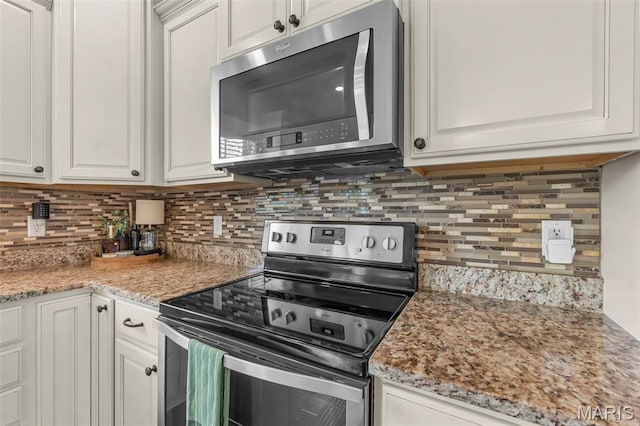 255 Sassenach Dr, Jackson, MO 63755 - kitchen featuring stainless steel appliances, decorative backsplash, white cabinets, and light stone counters