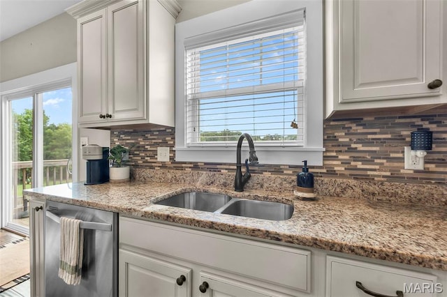 255 Sassenach Dr, Jackson, MO 63755 - kitchen with stainless steel dishwasher, tasteful backsplash, and white cabinetry