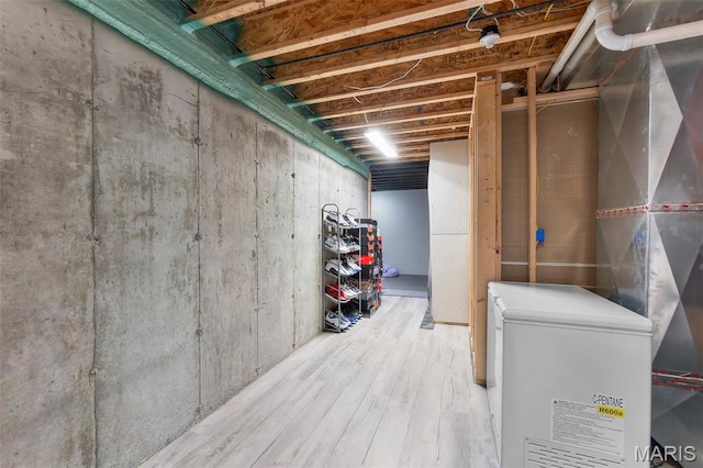 255 Sassenach Dr, Jackson, MO 63755 - unfinished basement with refrigerator and wood finished floors
