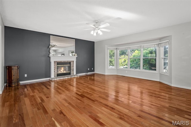 2849 Dardenne Links Dr, Dardenne Prairie, MO 63368 - unfurnished living room featuring a ceiling fan, wood finished floors, and a brick fireplace