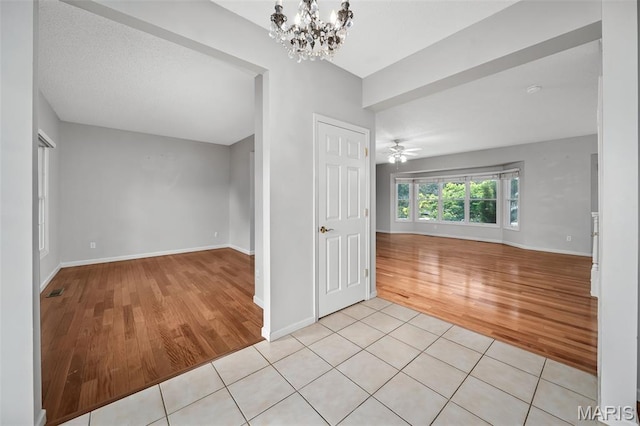 2849 Dardenne Links Dr, Dardenne Prairie, MO 63368 - empty room featuring light wood finished floors, a chandelier, and ceiling fan