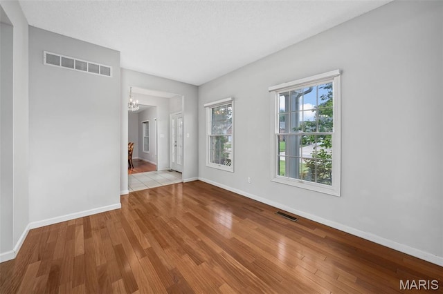 2849 Dardenne Links Dr, Dardenne Prairie, MO 63368 - empty room featuring a chandelier and wood finished floors