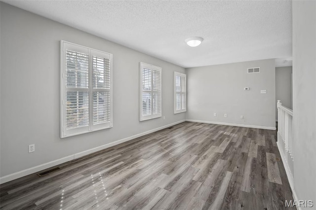 2849 Dardenne Links Dr, Dardenne Prairie, MO 63368 - unfurnished room featuring a textured ceiling and wood finished floors