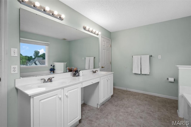 2849 Dardenne Links Dr, Dardenne Prairie, MO 63368 - bathroom with double vanity, a textured ceiling, and a tub