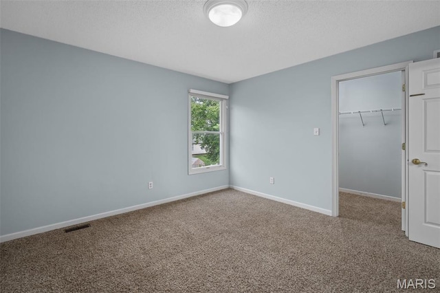 2849 Dardenne Links Dr, Dardenne Prairie, MO 63368 - unfurnished bedroom with carpet flooring, a spacious closet, and a textured ceiling
