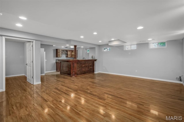 2849 Dardenne Links Dr, Dardenne Prairie, MO 63368 - unfurnished living room with wet bar, wood finished floors, and recessed lighting
