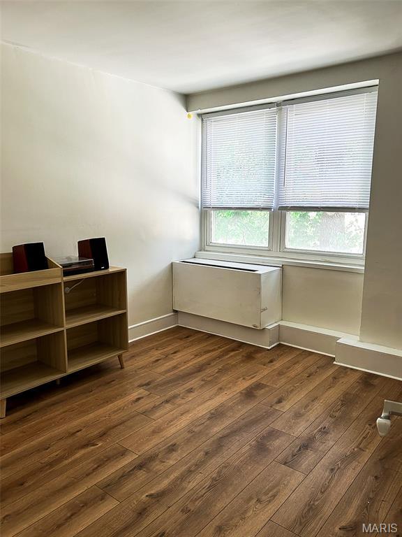210 N 17th St Unit 302, Saint Louis, MO 63103 - spare room with dark wood-style floors and baseboards