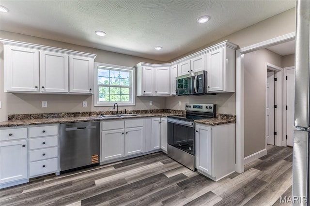 1507 Finn Dr, Lebanon, MO 65536 - kitchen with stainless steel appliances, white cabinets, dark wood-style floors, and recessed lighting