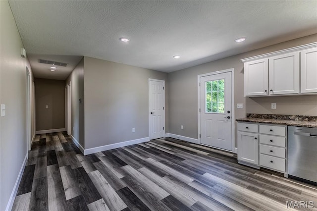 1507 Finn Dr, Lebanon, MO 65536 - kitchen with dishwasher, dark wood-type flooring, white cabinetry, recessed lighting, and dark stone counters