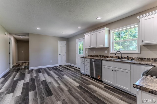 1507 Finn Dr, Lebanon, MO 65536 - kitchen featuring stainless steel dishwasher, white cabinets, dark wood-style flooring, recessed lighting, and dark countertops
