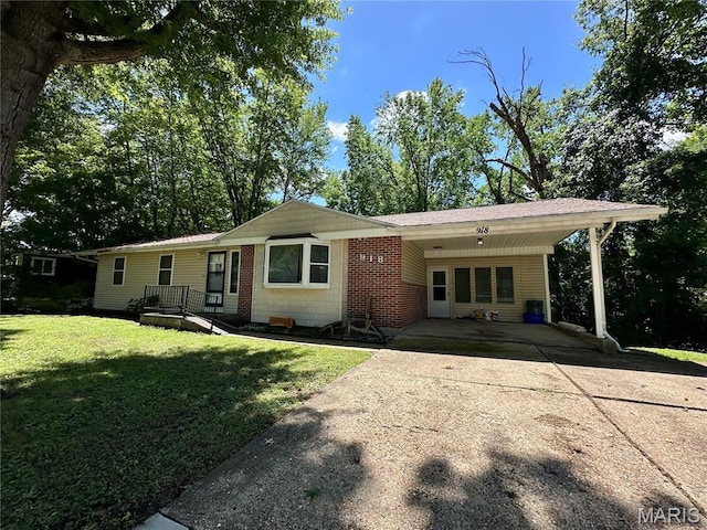 918 E 7th St, Rolla, MO 65401 - view of front of house featuring a front lawn, driveway, and an attached carport