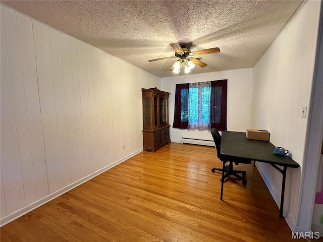 918 E 7th St, Rolla, MO 65401 - office space with baseboard heating, light wood-style floors, ceiling fan, and a textured ceiling