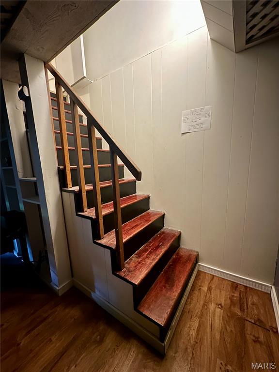 918 E 7th St, Rolla, MO 65401 - staircase with wood finished floors and a decorative wall