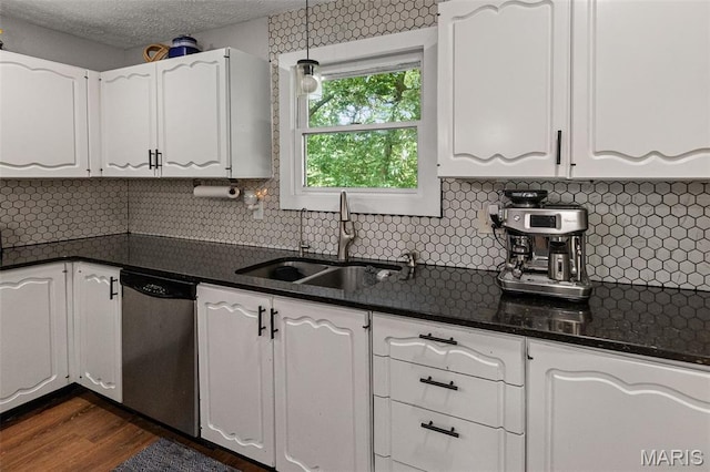 1716 Fountainbleu Dr, Worden, IL 62097 - kitchen featuring stainless steel dishwasher, white cabinetry, dark wood finished floors, tasteful backsplash, and a textured ceiling