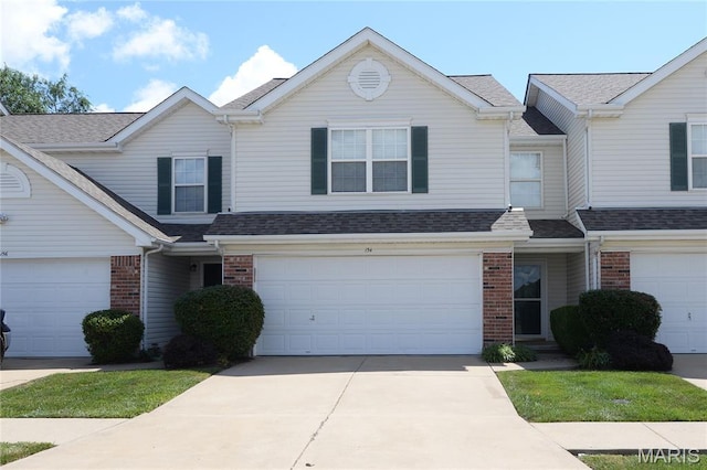 154 Homeshire Dr Unit 27, Wentzville, MO 63385 - traditional home featuring brick siding, a garage, driveway, and roof with shingles