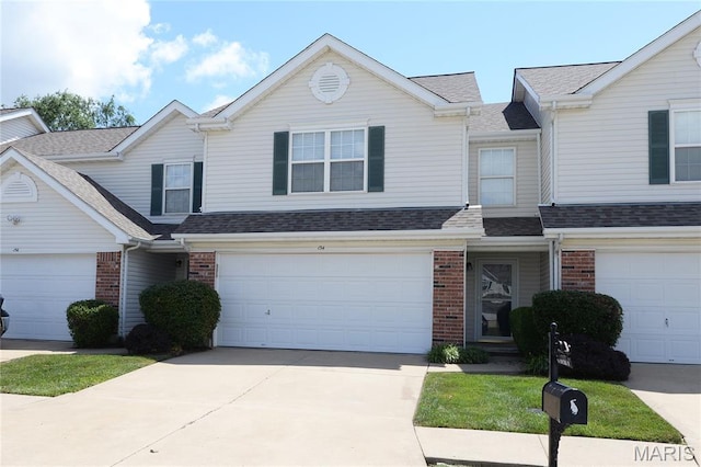 154 Homeshire Dr Unit 27, Wentzville, MO 63385 - traditional-style home featuring brick siding, roof with shingles, driveway, and a garage