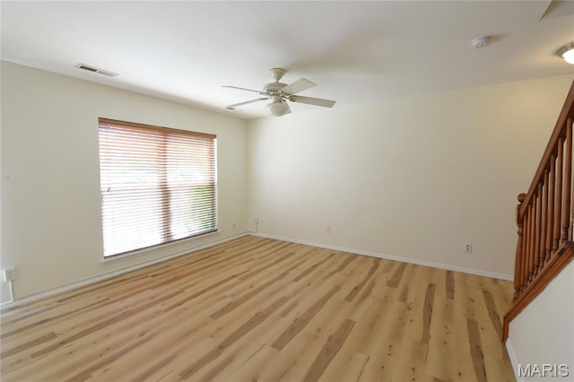 154 Homeshire Dr Unit 27, Wentzville, MO 63385 - spare room featuring light wood-type flooring, stairs, and ceiling fan