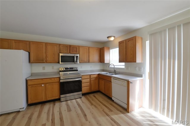 154 Homeshire Dr Unit 27, Wentzville, MO 63385 - kitchen featuring appliances with stainless steel finishes, light countertops, and light wood finished floors