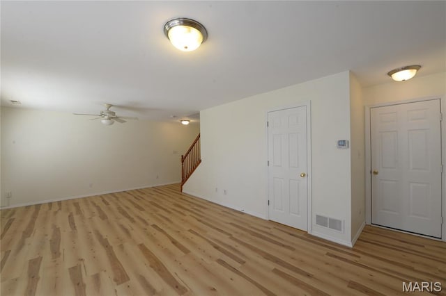 154 Homeshire Dr Unit 27, Wentzville, MO 63385 - unfurnished living room with light wood-style floors, a ceiling fan, and stairs