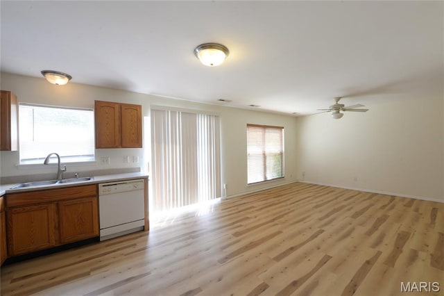 154 Homeshire Dr Unit 27, Wentzville, MO 63385 - kitchen with white dishwasher, light wood-style floors, brown cabinetry, and light countertops
