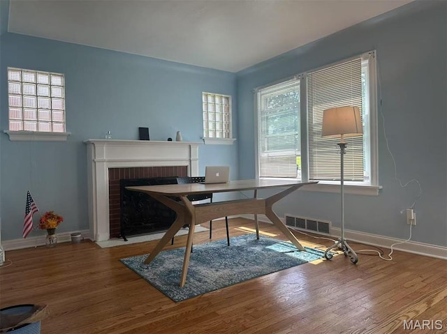 3525 Belaire Pl, Beverly Hills, MO 63121 - office featuring wood finished floors and a fireplace