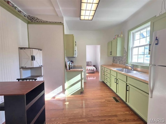 315 W State St, Union, MO 63084 - kitchen with green cabinetry, freestanding refrigerator, light wood-type flooring, and butcher block counters
