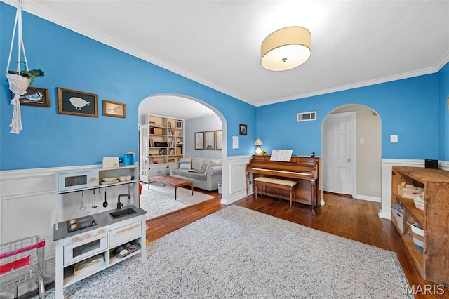 100 Calverton Rd, Saint Louis, MO 63135 - bedroom featuring arched walkways, wood finished floors, crown molding, and a wainscoted wall